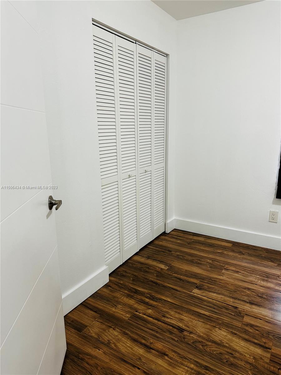26232 Southwest 124th Place Homestead, FL 33032 - Photo 21 of 33 a view of a room with wooden floor and cabinet