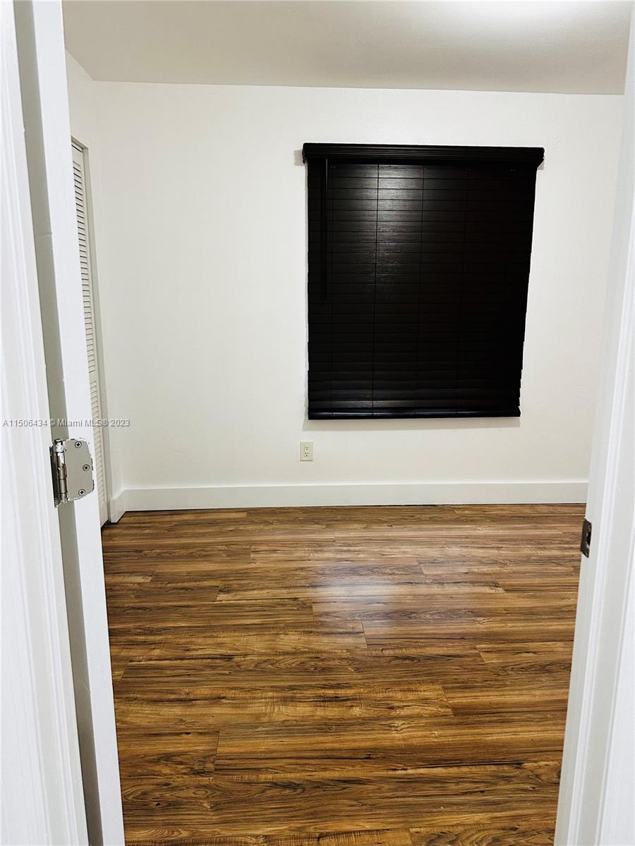 26232 Southwest 124th Place Homestead, FL 33032 - Photo 22 of 33 a view of room with wooden floor