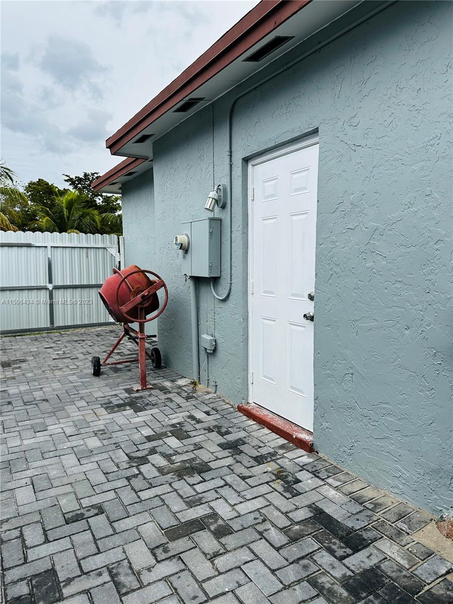 26232 Southwest 124th Place Homestead, FL 33032 - Photo 31 of 33 a backyard of a house with blue table and chairs
