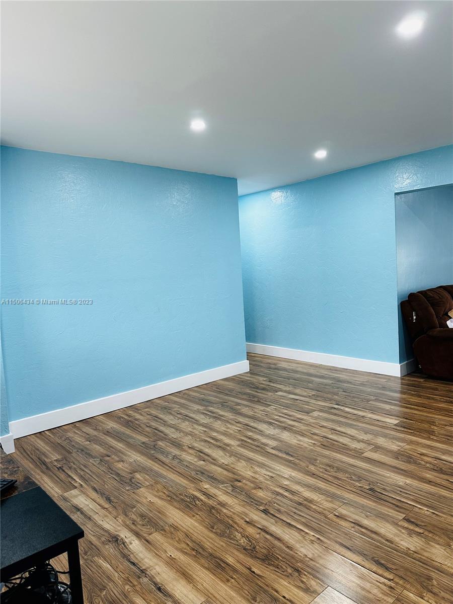 26232 Southwest 124th Place Homestead, FL 33032 - Photo 4 of 33 a view of room with wooden floor