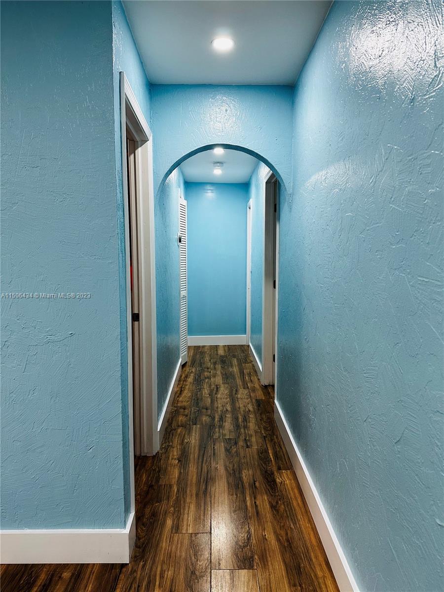 26232 Southwest 124th Place Homestead, FL 33032 - Photo 7 of 33 a view of a hallway with wooden floor