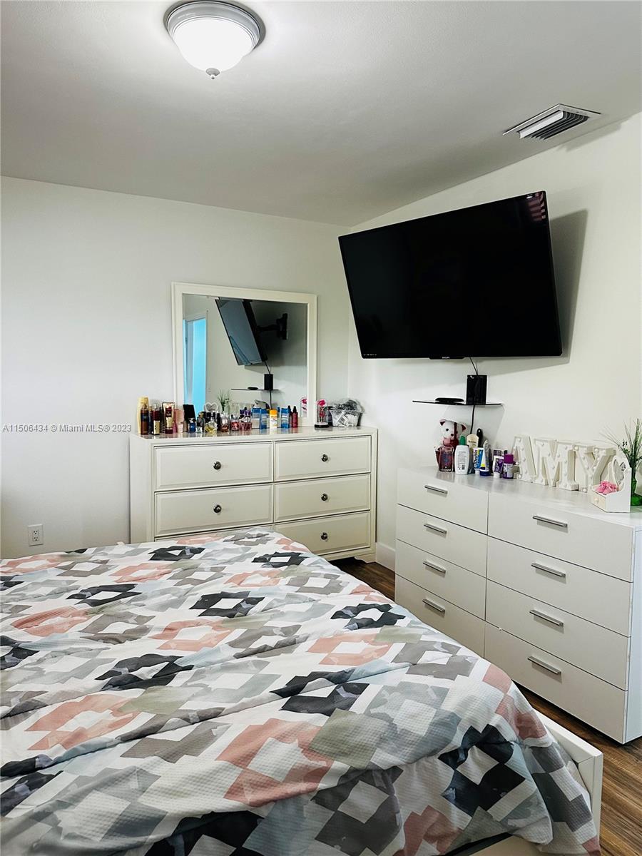 26232 Southwest 124th Place Homestead, FL 33032 - Photo 10 of 33 a bedroom with a bed and flat screen tv