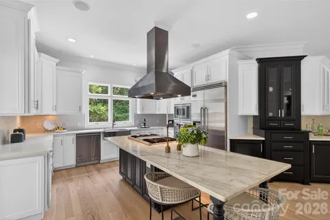 a kitchen with a table chairs stove and cabinets