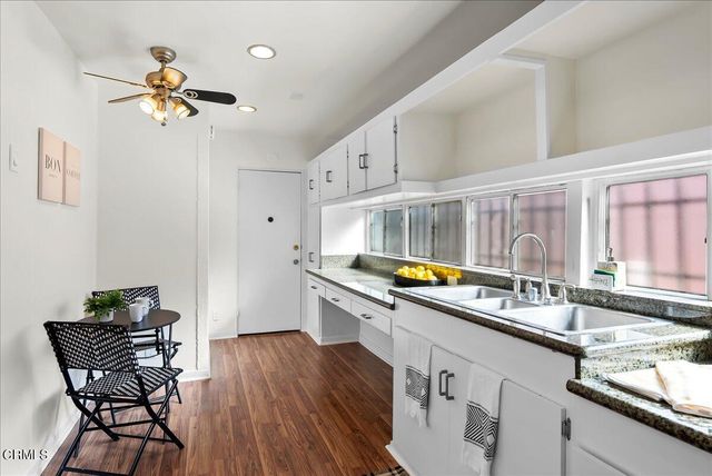 a kitchen with stainless steel appliances granite countertop a sink and cabinets