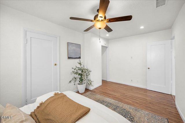 a bedroom with a bed and a potted plant