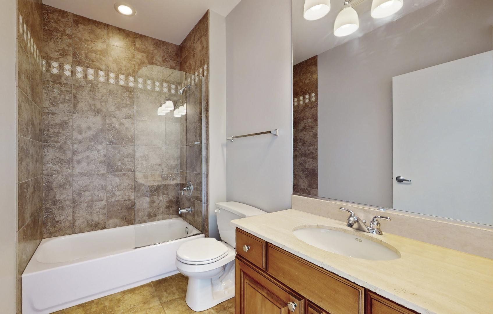 915 North Howe Street Chicago, IL 60610 - Photo 22 of 30 a bathroom with a bathtub shower sink mirror vanity and toilet