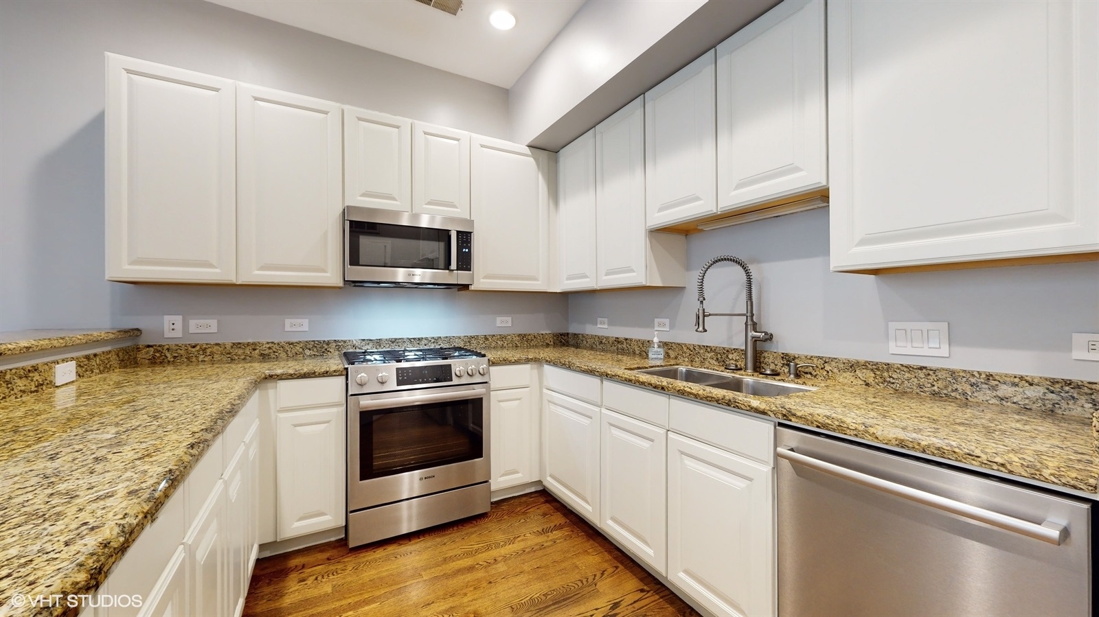 915 North Howe Street Chicago, IL 60610 - Photo 8 of 30 a kitchen with stainless steel appliances granite countertop a sink stove and cabinets