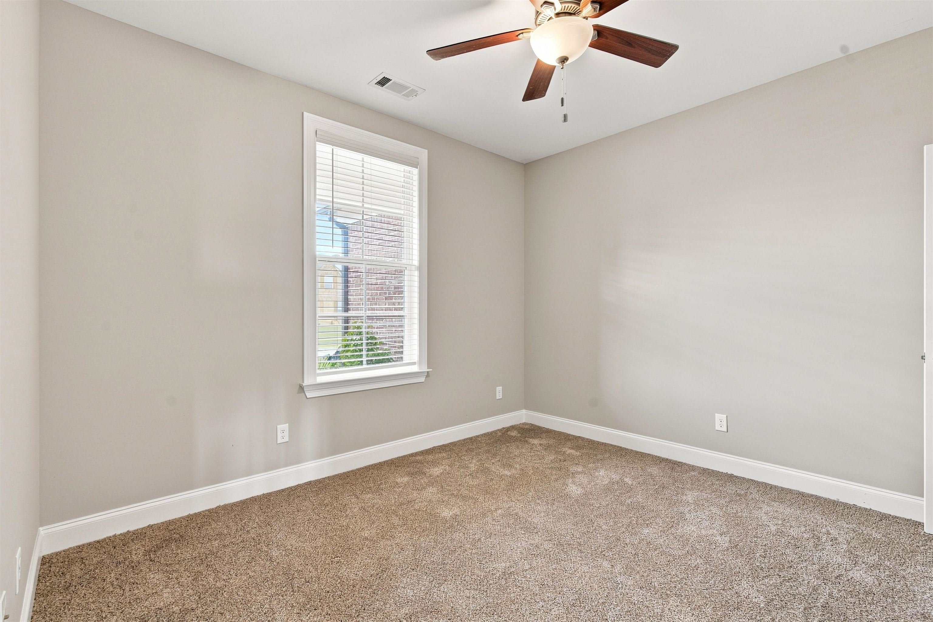 70 Trinity Cove Atoka, TN 38004 - Photo 15 of 19 Neutral wall tones, carpet flooring, a window with blinds, and a ceiling fan with light fixture