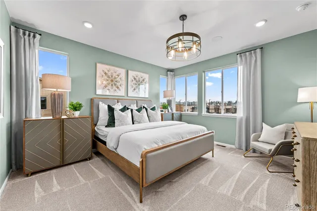 a spacious bedroom with a bed and a large window