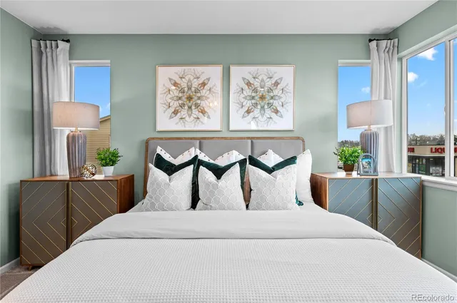 a bedroom with furniture and a large window