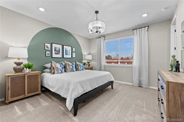 a spacious bedroom with a bed window and wall painting