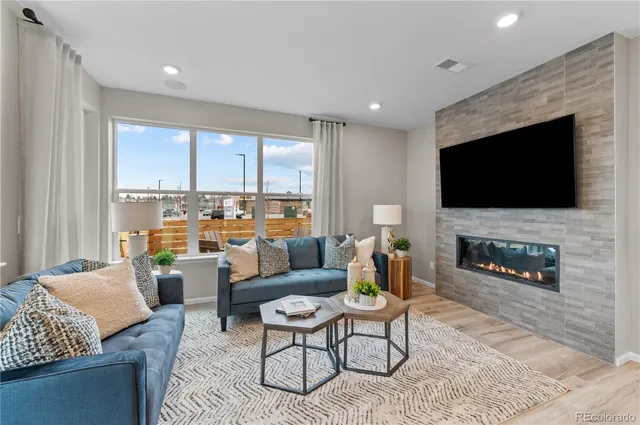 a living room with fireplace furniture and a flat screen tv