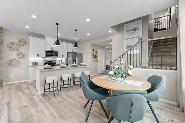 a view of a dining room with furniture and wooden floor