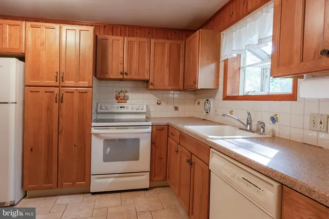 a kitchen with a sink cabinets and a window