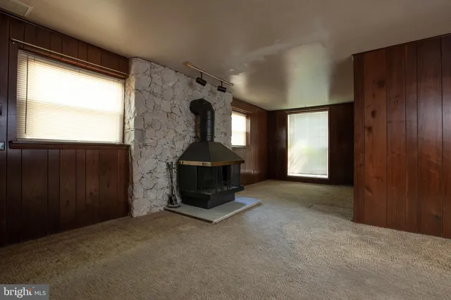a living room with furniture a fireplace and a window