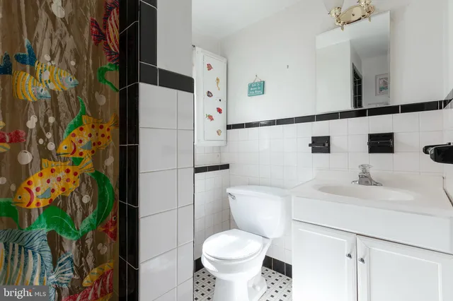 a white toilet sitting next to a bathroom sink
