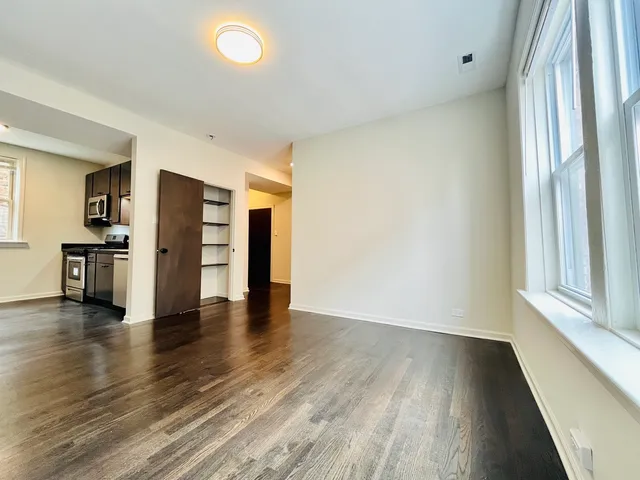 a kitchen with granite countertop stainless steel appliances a refrigerator and a stove top oven