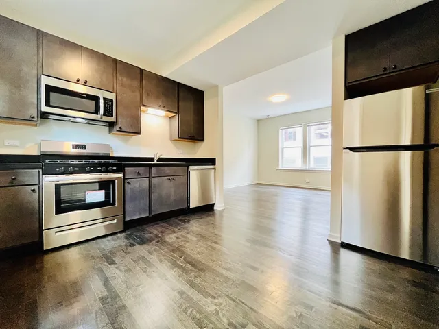 a kitchen with a refrigerator stove and microwave