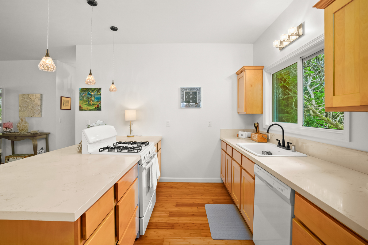 6390 Kalama Road Kapaa, HI 96746 - Photo 7 of 21 a kitchen with a sink stove and cabinets