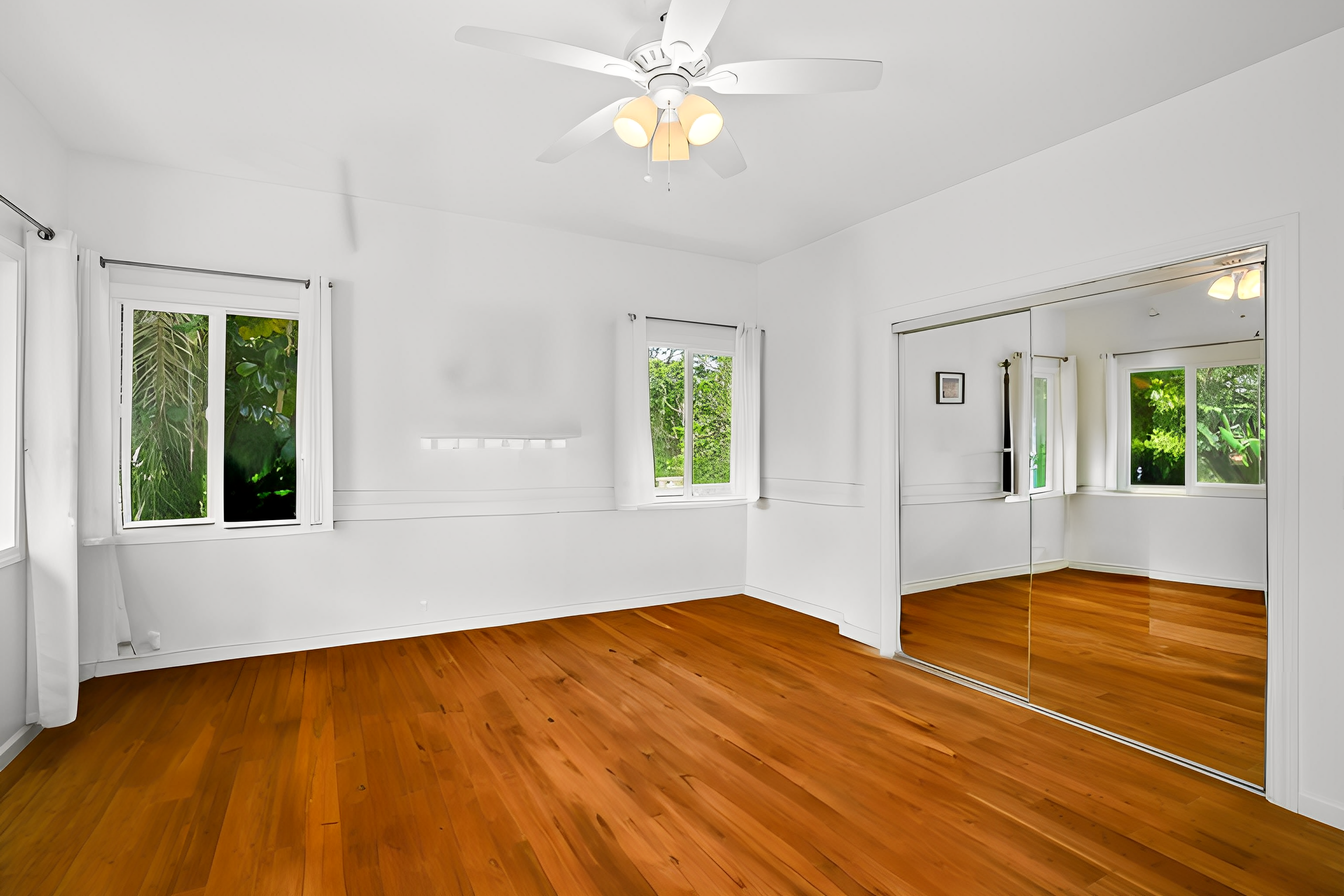 6390 Kalama Road Kapaa, HI 96746 - Photo 9 of 21 a view of an empty room with window and wooden floor