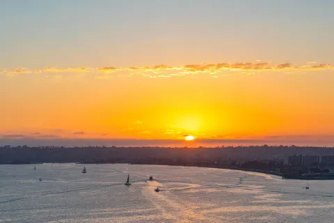 a view of an ocean beach and mountain
