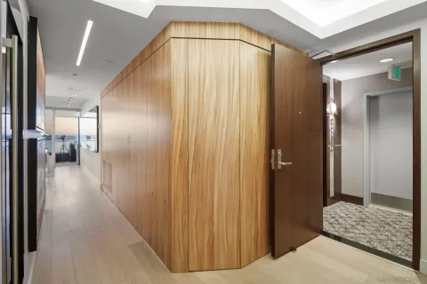 a spacious bedroom with a bed and a chandelier