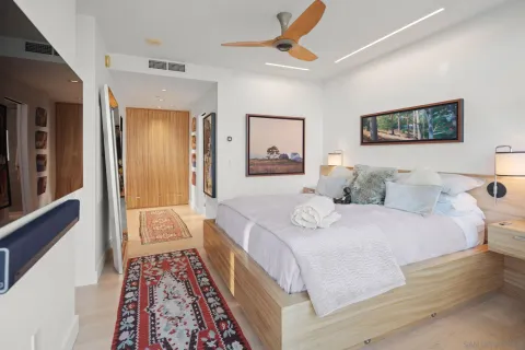 a bedroom with a large bed couch and a window