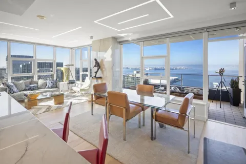 a living room with couches a coffee table and chairs with outer view