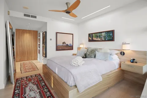 a view of a hallway with wooden floor and windows