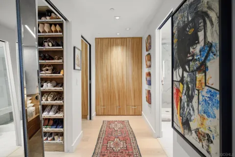 a view of walk in closet with clothes and shoes