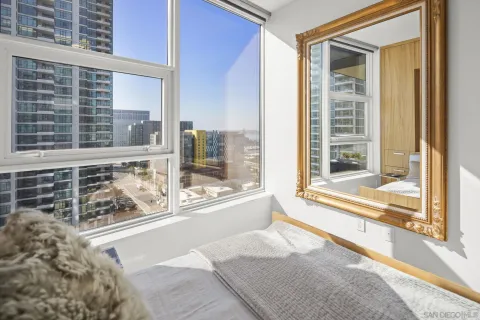 a bedroom with a bed and a flat screen tv