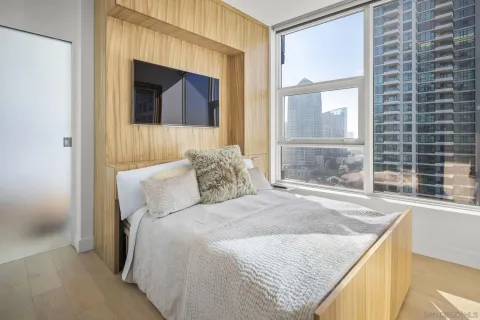 a bedroom with a bed and a window
