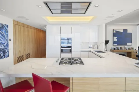 a kitchen with kitchen island granite countertop a sink stainless steel appliances and cabinets