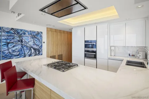 a kitchen with a stove a refrigerator and wooden cabinets