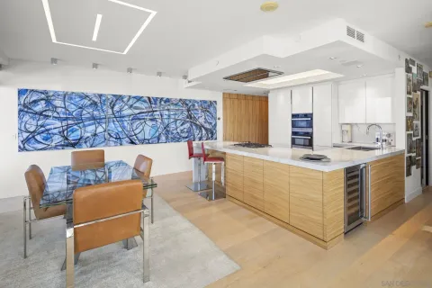 a living room with furniture and kitchen view