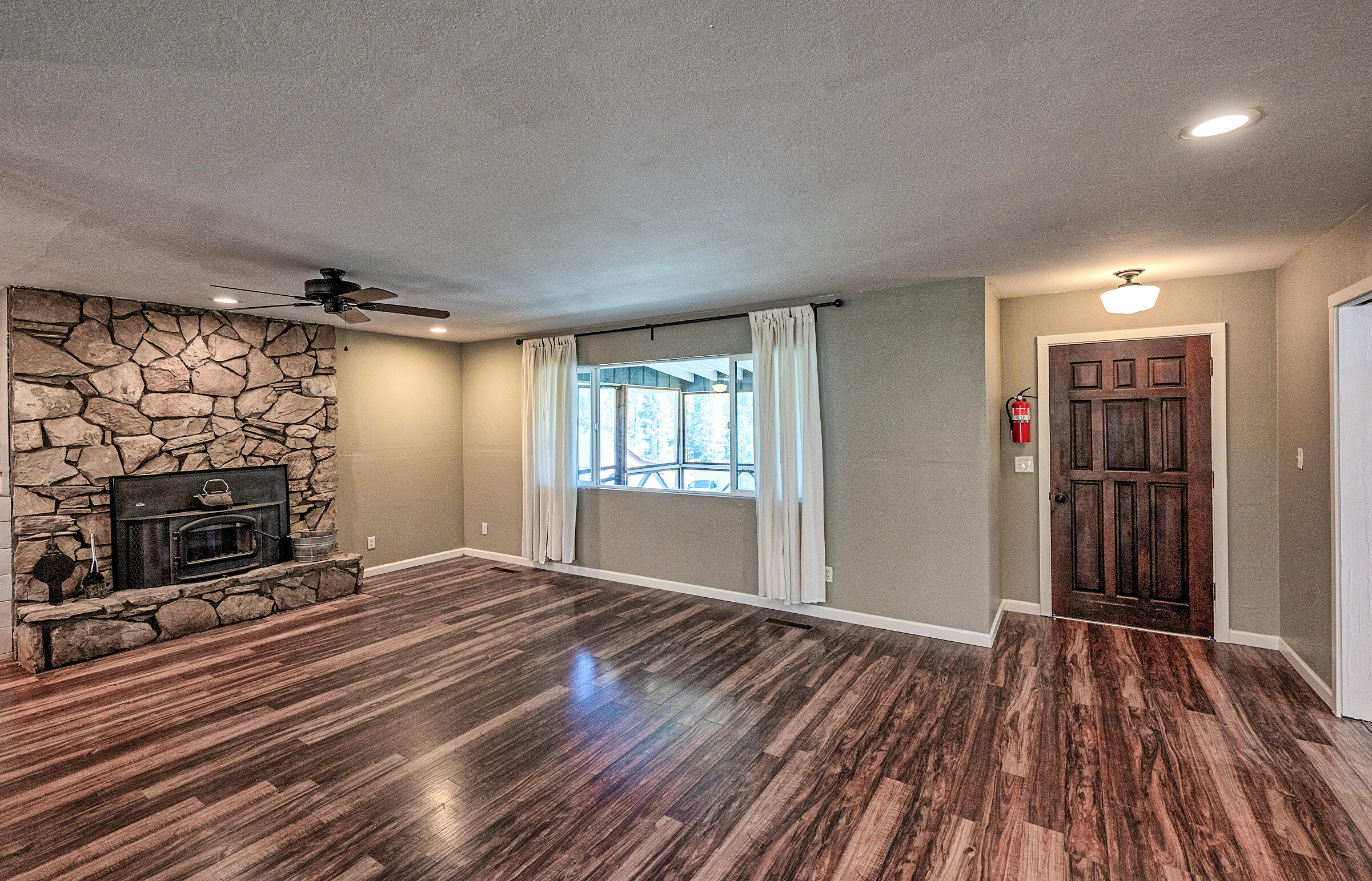 1765 Goose Ranch Road Lewiston, CA 96052 - Photo 17 of 83 a view of an empty room with wooden floor fireplace and a window