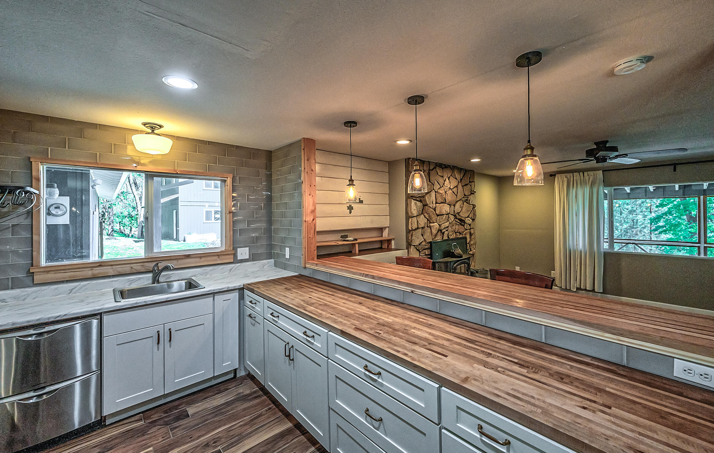 1765 Goose Ranch Road Lewiston, CA 96052 - Photo 21 of 83 a large kitchen with kitchen island white cabinets and wooden floor