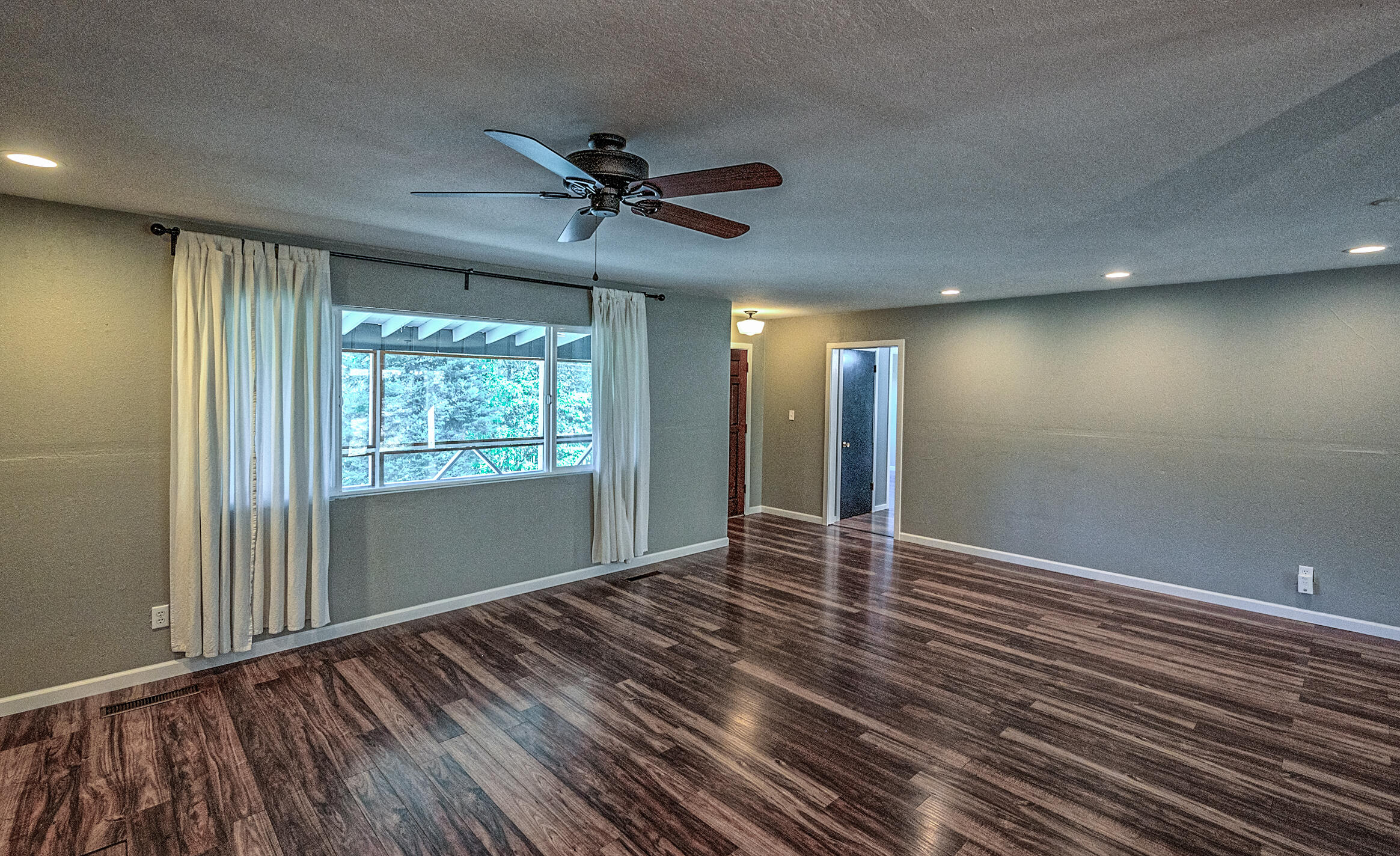 1765 Goose Ranch Road Lewiston, CA 96052 - Photo 27 of 83 an empty room with wooden floor fan and windows