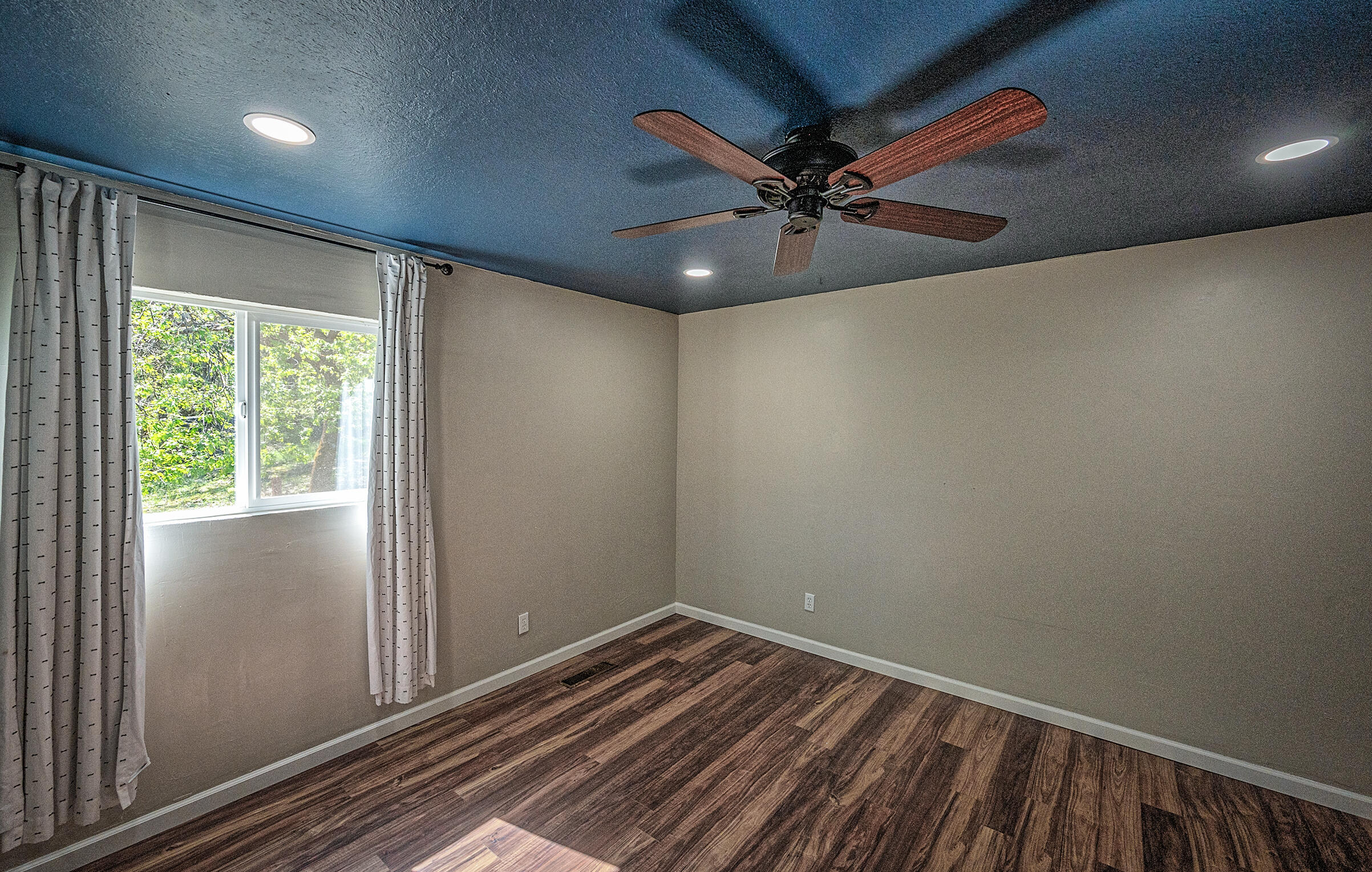 1765 Goose Ranch Road Lewiston, CA 96052 - Photo 37 of 83 an empty room with wooden floor fan and windows