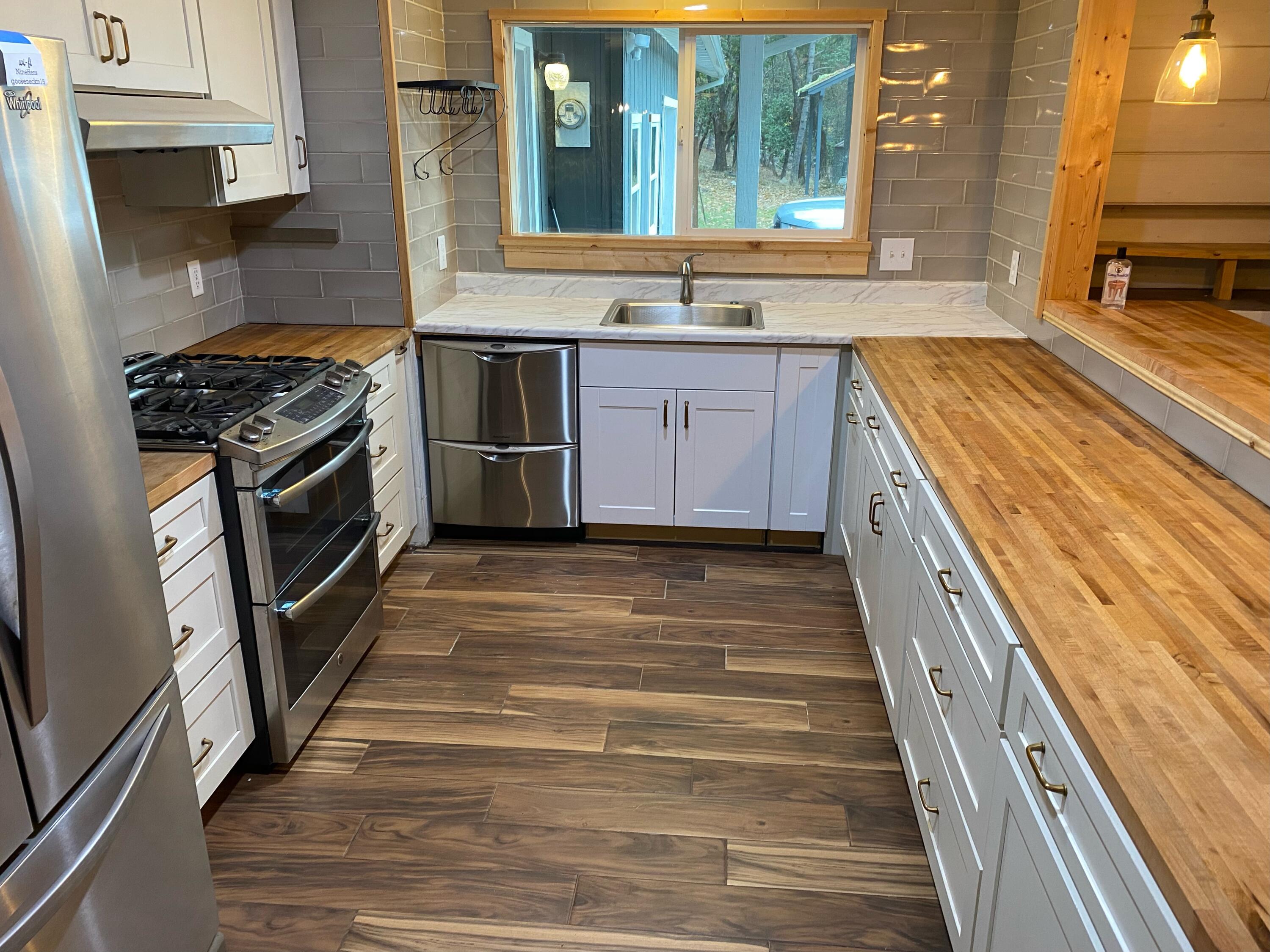 1765 Goose Ranch Road Lewiston, CA 96052 - Photo 57 of 83 a kitchen with stainless steel appliances granite countertop a stove a sink and a microwave