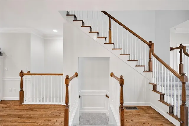 a view of hallway with stairs and wooden floor