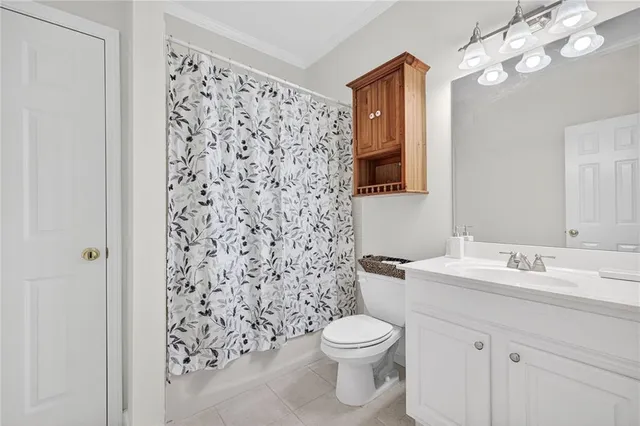 a bathroom with a sink a toilet and shower curtain