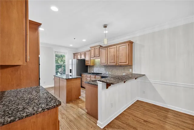a kitchen with stainless steel appliances granite countertop a stove and a sink