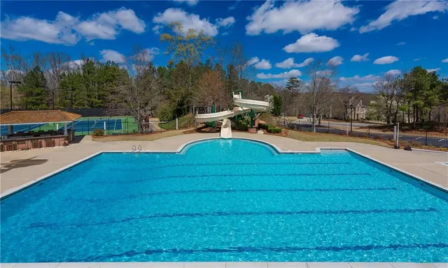 a view of a swimming pool with lounge chairs