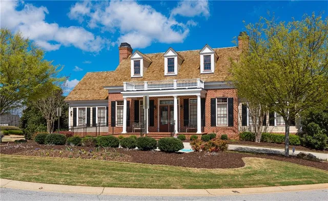 a view of a swimming pool with a lawn chairs and a fire pit