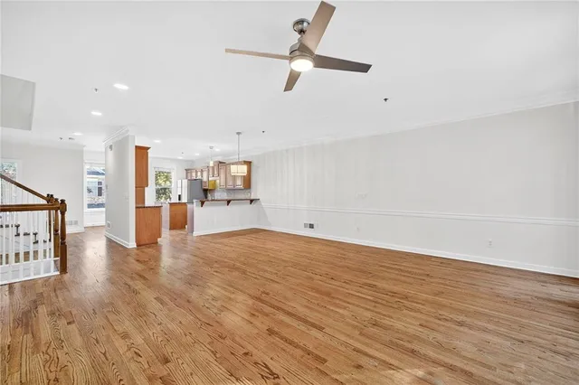 a view of empty room with wooden floor and window