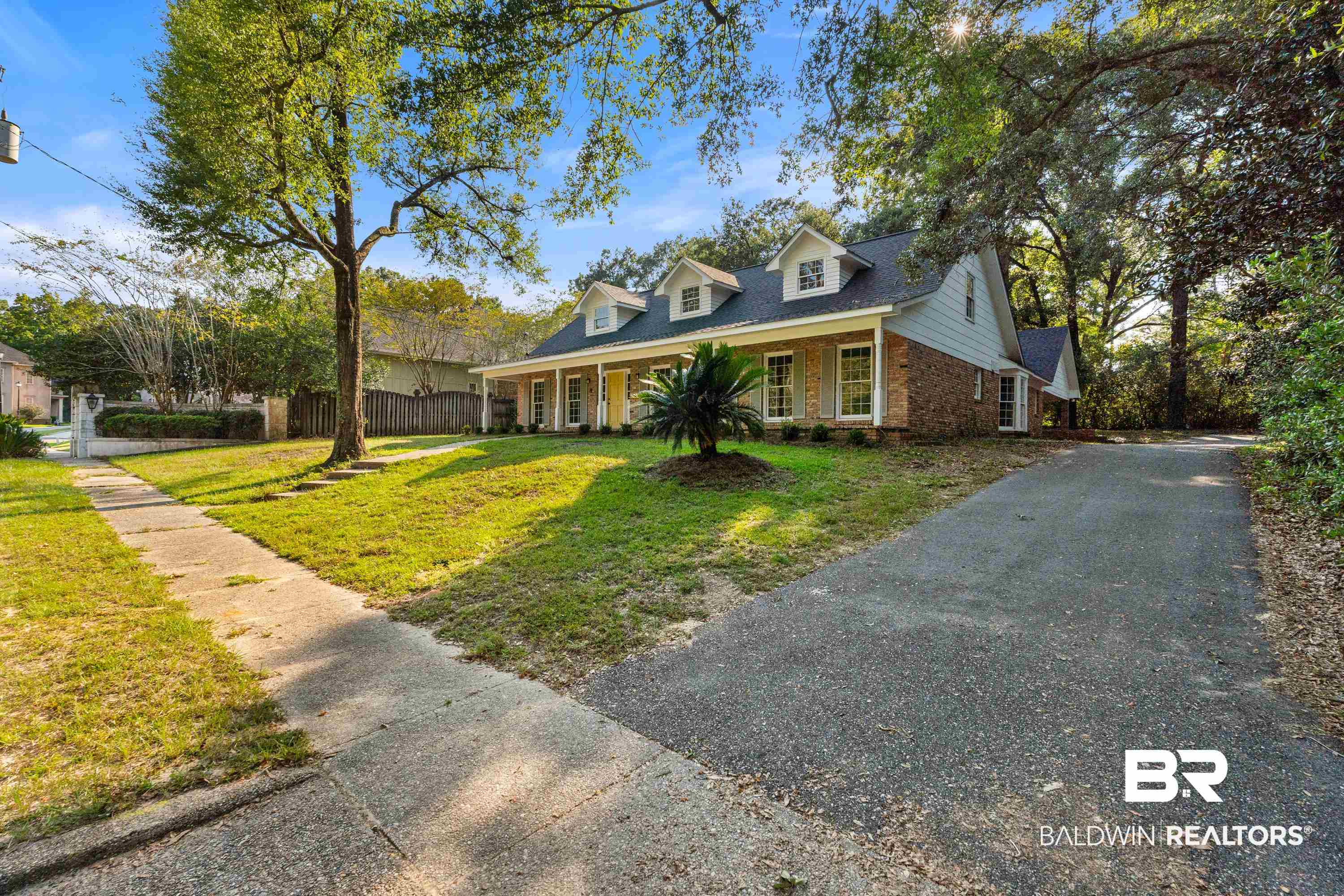 728 Spring Station Road Mobile, AL 36609 - Photo 31 of 35 New england style home with covered porch, brick siding, driveway, and roof with shingles