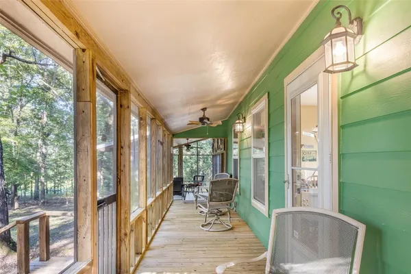 a view of a balcony with couch and wooden floor