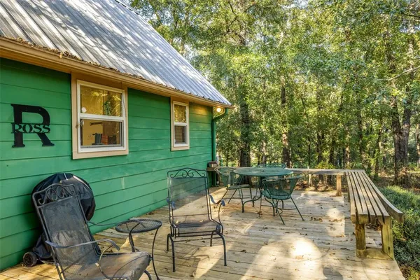 a view of a patio with table and chairs and potted plants