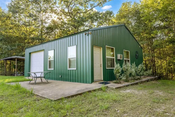 a view of a chair and table in the garden